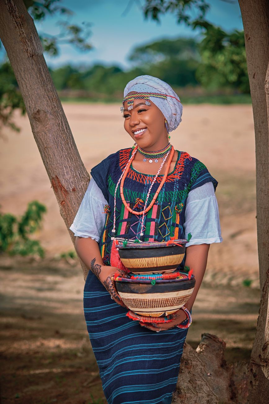 traditional nigerian woman with baskets outdoors